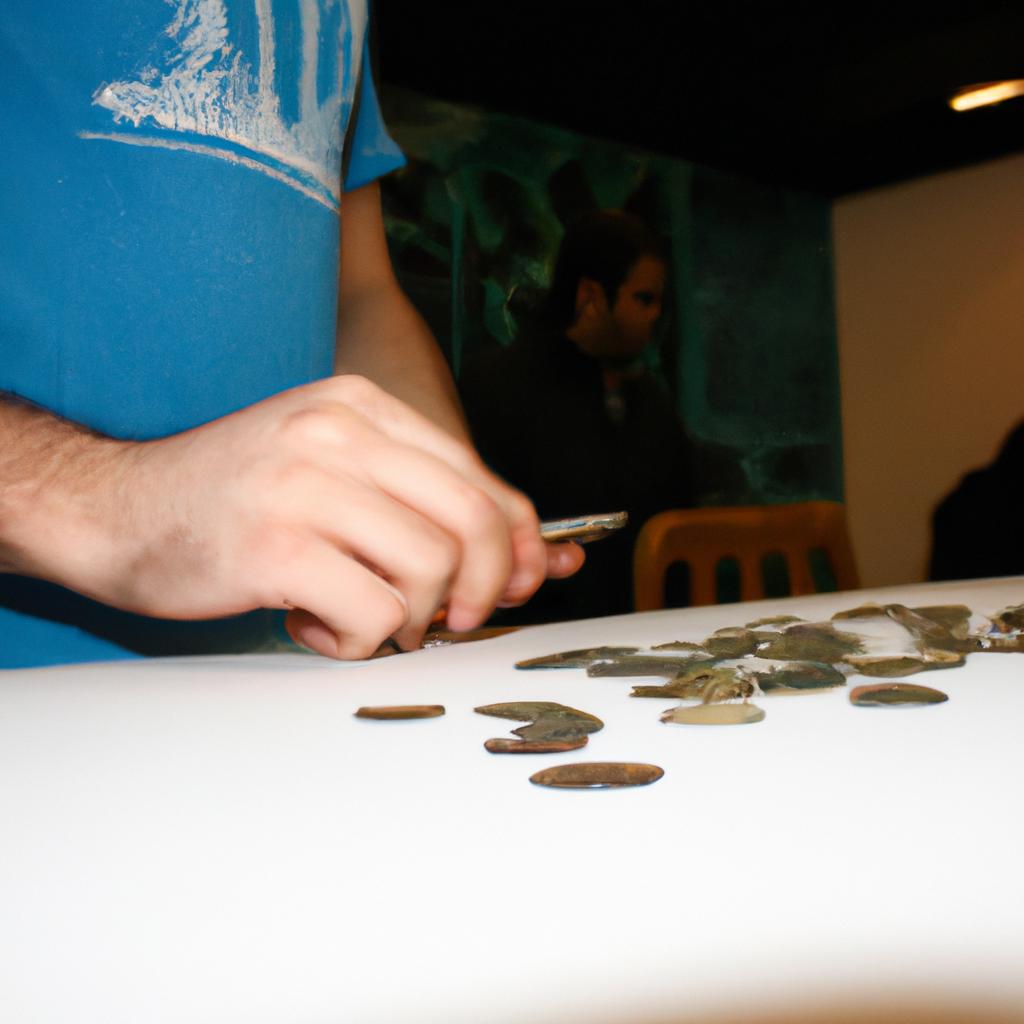 Person examining coins at auction